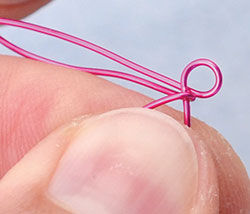 Hands wrapping wire loop